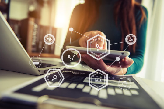 Businesswoman hand working digital marketing media in virtual screen with mobile phone and modern compute with VR icon diagram at office in morning light