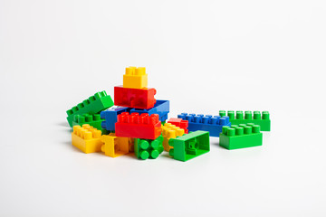 Naklejka premium Multicolored designer parts on an isolated white background. Educational toys, logic. Banner