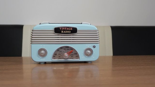 Vintage radio moving on a retro table.
