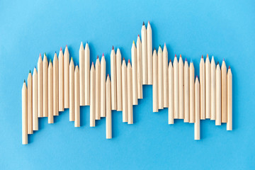 artistic tools, drawing, creativity and object concept - chart of many coloring pencils on blue background