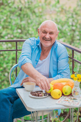 Portrait Of A Happy Mature man at morning, breakfast. Concept of senior lifestyle 