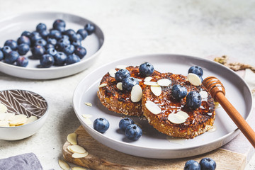 Tofu pancakes with blueberries and honey on gray plate. Healthy vegan food concept.