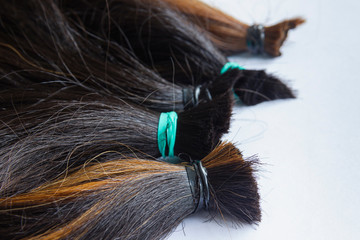 hair tied together for do wig on with background, donated to people with cancer
