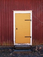 Obraz na płótnie Canvas Yellow Door On A Red Wall