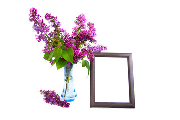 Bouquet of lilac flowers in a vase with a frame for your photo or quote on a white background background.