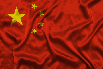 China national flag background with fabric texture. Flag of PRC waving in the wind.
