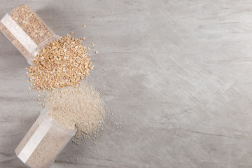 Cans of rice and oatmeal are scattered on the table. Useful complex carbohydrates, proper nutrition.