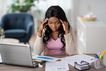 remote job, technology and people concept - stressed young african american woman with laptop...