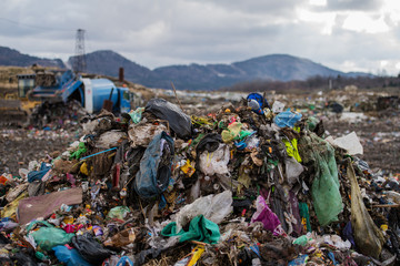 Waste heaps on landfill, environmental concept. Copy space.
