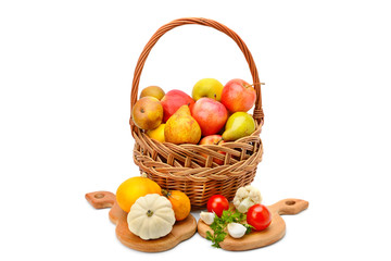 Vegetables and fruits in a basket isolated on white background.