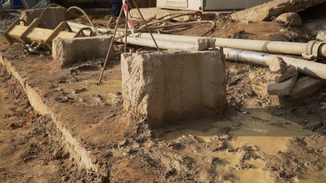 Closeup of narrow quarry or foundation pit for the construction of multi story building.