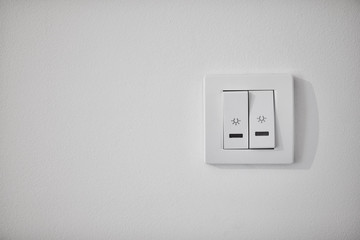 Modern light switch on a white wall.
