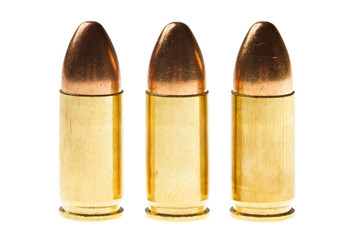 Shiny 9 mm caliber Bullets. Close-up of a 9mm full metal jacket ammo isolated on white background with reflection