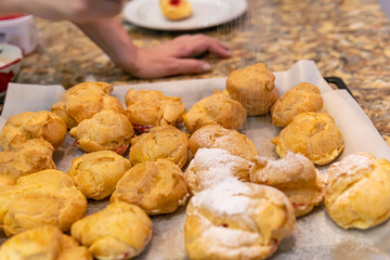 Process of cooking custard cakes by woman at domestic kitchen