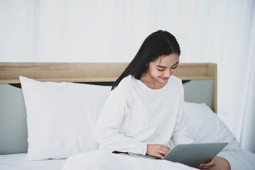 Asian woman use notebook work and shopping online from home