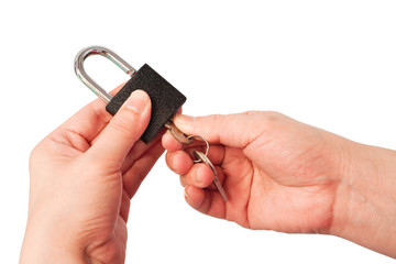 Hands hold master key to unlock black padlock isolated on white background, find the right solution...