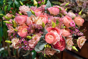 Close-up of beautiful multi-colored bouquet of mixed roses and other flowers in a shop. Fresh cut flowers.