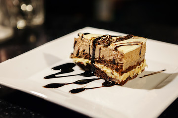 A slice of cake on a white plate.