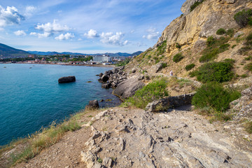 Beautiful summer sea landscape at the resort in the Crimea. View of the city from the mountain trail. Rocky coast of the black sea. Seascape.