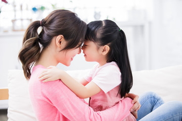 Mom hold daughter in her arm