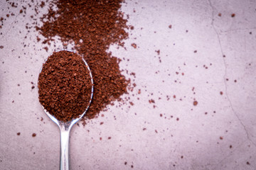 Coffee beans and spoon on vintage floor