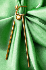 Earrings on green satin
