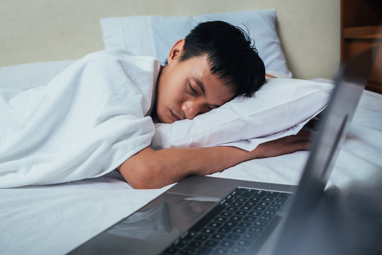 Tired Business Man Sleeping In Bed With Laptop, Hard Work, Working From Home WFH Concept.