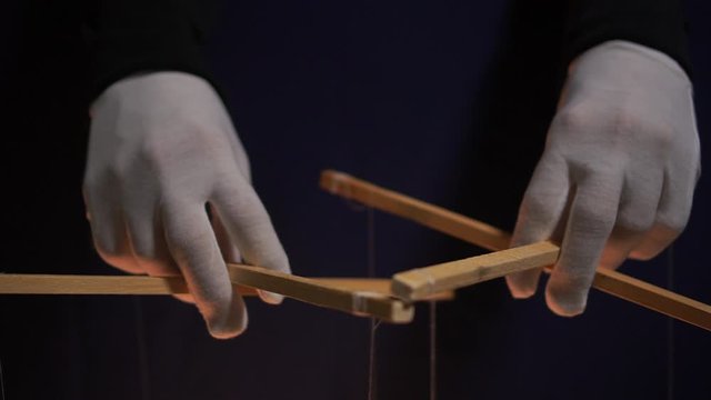 Puppet theatre. Puppet master and marionettes. Manipulations with the mind and actions of people concept