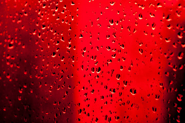 Blue water drops background. Drops of water on a red background. Drops of water on glass. 