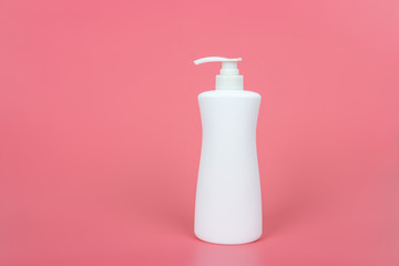Cosmetic mock up bottle on pastel pink background