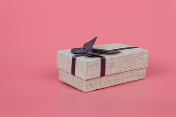Gift box on a pastel pink background, present for Christmas, new year, mother's day, anniversary, birthday and party