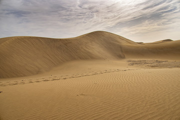 summer desert landscape on a warm sunny day from Maspalomas dunes on the Spanish island of Gran...