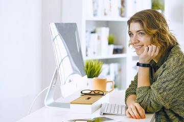 Young woman working with graphic tablet in office
