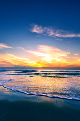 Fototapeta na wymiar Scenic view of sand beach at the sea in morning sunrise sky.