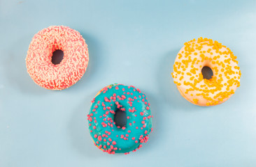 Assorted three donuts, on a blue background