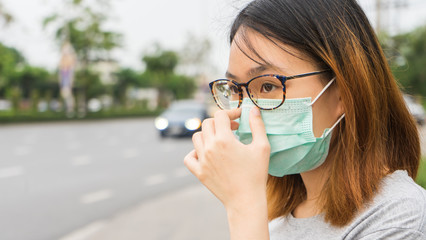 A woman wearing protective face mask and cough, get ready for prevent Coronavirus and pm 2.5 . Hygiene concept