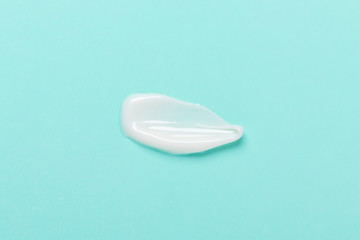 Cosmetic clay mask for face and body. White texture on blue background. Close-up