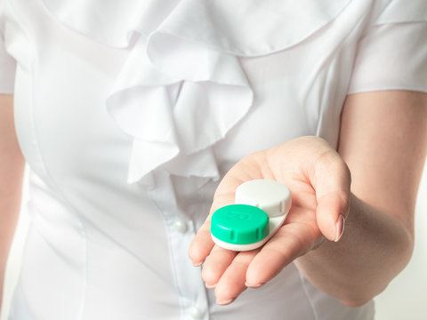 Cropped view of ophthalmologist holding contact lenses in hands. Eyesight and eyecare concept.
