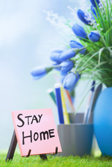 Adhesive note with Stay Home text at the green office