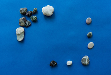 Pebbles in a sunbeam on a blue background.