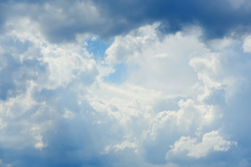 White clouds on the blue sky. Sunny day.