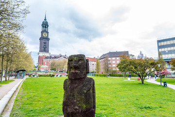 A stone sculpture and background of clock tower of Church of St. Michael, Hamburg, Germany. A landmark of the city and it is considered to be one of the finest Hanseatic Protestant baroque churches