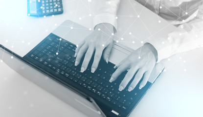 Businesswoman typing on a laptop; light effect
