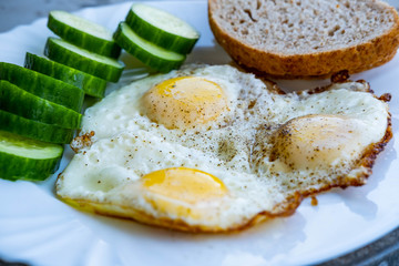 Close up of fried eggs vegetables and bread