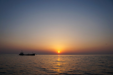 Naklejka na ściany i meble beautiful sunrise and ship on sea 