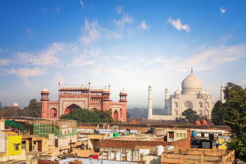 Fototapeta na wymiar Agra view: poor houses and Taj Mahal, India