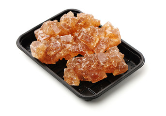 dark crystal sugar on white background