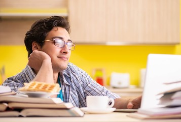 Student preparing for exam sitting at the kitchen