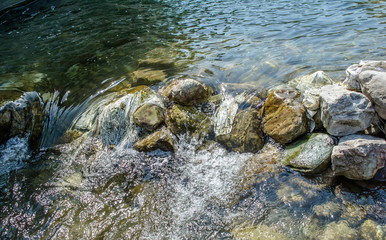 Stone under crystal clear water of  Ganga River at Rishikesh
