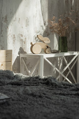 Photo of a wooden rabbit on wheels of beech in bright bedroom.